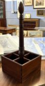 A reproduction Georgian style mahogany four bottle stand