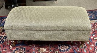 A 20th Century storage footstool on turned legs with brass casters