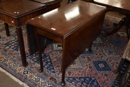 A George III mahogany drop leaf dining table raised on tapering legs with pad feet, 99cm wide when