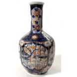 A Japanese porcelain vase Meiji period, the ribbed body decorated in Imari style with tapered