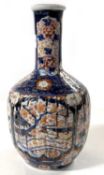 A Japanese porcelain vase Meiji period, the ribbed body decorated in Imari style with tapered