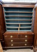 A Georgian mahogany side cabinet with moulded cornice over two astragal glazed doors opening to a
