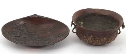 A Japanese metal shell dish decorated with figures in relief together with a further small bowl,