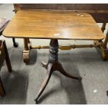 A Georgian mahogany supper table, the rectangular top over a turned column and tripod base with