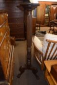 A large late 19th or early 20th Century mahogany torchere stand raised on tripod base with ball