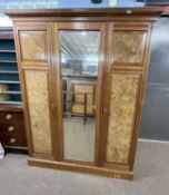 A late Victorian walnut and burr walnut veneered wardrobe with moulded cornice over a body with