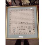A needlework sampler decorated with a stylised floral border and rows of religious text singed