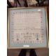A needlework sampler decorated with a stylised floral border and rows of religious text singed - Image 1 of 4