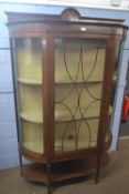 An Edwardian mahogany bow front china display cabinet with single door with applied stringing