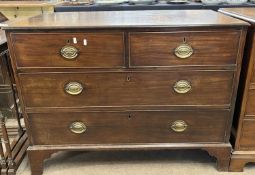 A George III mahogany chest of two short over two long drawers fitted with oval brass handles and