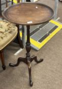 A Georgian Revival mahogany wine table, the circular dished top over a turned column and tripod