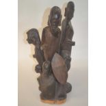 An African wooden carved group of warriors and children, 45cm high