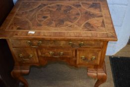 An 18th Century style walnut low boy with one long and three short drawers raised on cabriole