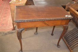 A Georgian mahogany card table of hinged rectangular form raised on tapering legs with ball and claw