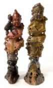 Two soapstone carvings of Chinese immortals on rocky bases, tallest 20cm high