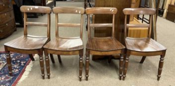 A set of four 19th Century mahogany hard seat kitchen chairs