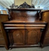 A Victorian mahogany chiffonier with a scrolled pediment over a single shelf and swans head