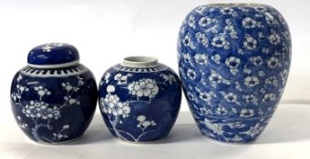 A Chinese porcelain ginger jar and cover with prunus on a blue ground, together with a further