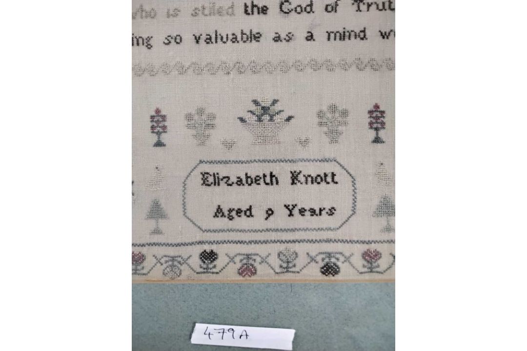 A needlework sampler decorated with a stylised floral border and rows of religious text singed - Image 3 of 4