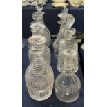 A collection of eight mid 19th Century decanters, hobnail cut and strawberry cut designs, also