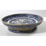 A mid 19th Century Staffordshire pottery dish with Willow pattern, 26cm diameter