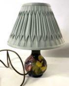 A Moorcroft table lamp, the body decorated with the Hibiscus pattern, the ceramic lamp 16cm high
