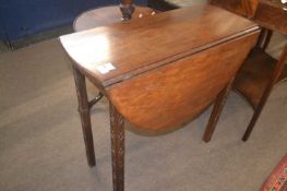 A small 18th Century mahogany drop leaf table raised on legs with blind fretwork detail, 76cm wide