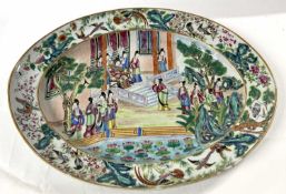 A 19th Century Cantonese dish of oval shape, the centre painted in typical style with Chinese