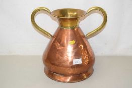A copper and brass handled pot