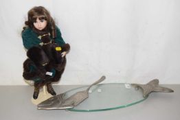 A collectors doll and a fish serving plate