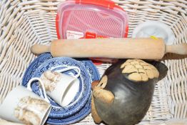 A basket with a pottery owl, dinner wares, pestle etc