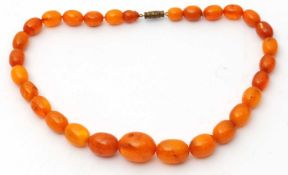 A butterscotch amber bead necklace, with graudated oval beads between approx. 7 -16mm diameter, 40cm