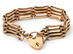 A 9ct gate bracelet, the 13mm wide bracelet stamped at each end 9ct, with padlock clasp stamped 9ct,