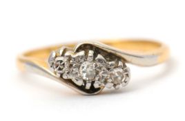 A diamond ring, the crossover style ring with three illusion set single cut diamonds, with plain