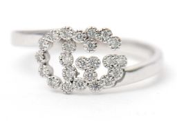 A diamond ring, with two interlocking diamond set 'GG', with plain band stamped 'AU 750', size L,