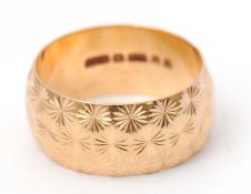 A 9ct gold ring, 8.6mm wide with all around decoration, hallmarked London 1978, size N-O, 5.4g