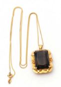 A smokey quartz pendant and chain, the pendant with a modified radiant cut smokey quartz, 25mm long,
