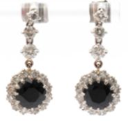 A pair of synthetic sapphire and white stone earrings, all set in unmarked white and yellow metal,
