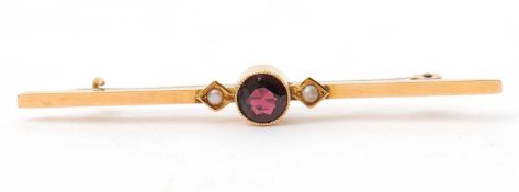 A garnet and seed pearl bar brooch, with central round garnet in millegrain collet mount, with a