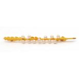 A 15ct seed pearl brooch, the brooch modelled as a floral blade with white seed pearls, stamped 15ct
