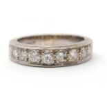 A half eternity diamond ring, set with round brilliant cut diamonds and plain band stamped 18ct,