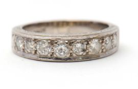 A half eternity diamond ring, set with round brilliant cut diamonds and plain band stamped 18ct,