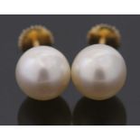 A pair of 'pearl' studs, cased by Asprey, the round 'pearls', each approx. 8.8mm diameter, cup