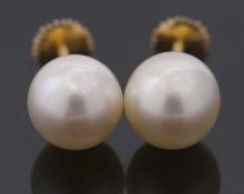 A pair of 'pearl' studs, cased by Asprey, the round 'pearls', each approx. 8.8mm diameter, cup