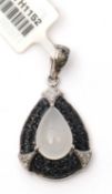 A gemset pendant, the pear shape pendant with central moonstone and pave sapphire surround with