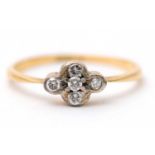 A diamond ring, set with five small round brilliant cut diamonds and plain band stamped 18ct, size