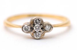 A diamond ring, set with five small round brilliant cut diamonds and plain band stamped 18ct, size