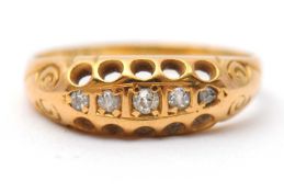 A five stone diamond ring, set with five small old mine and rose cut diamonds, with plain band