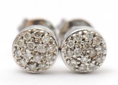 A pair of diamond earrings, the slightly domed diamond pave set discs, 6mm diameter, stamped 18k,