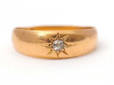 A late 19th century 18ct diamond ring, with gypsy set diamond, tapering shoulders and plain band